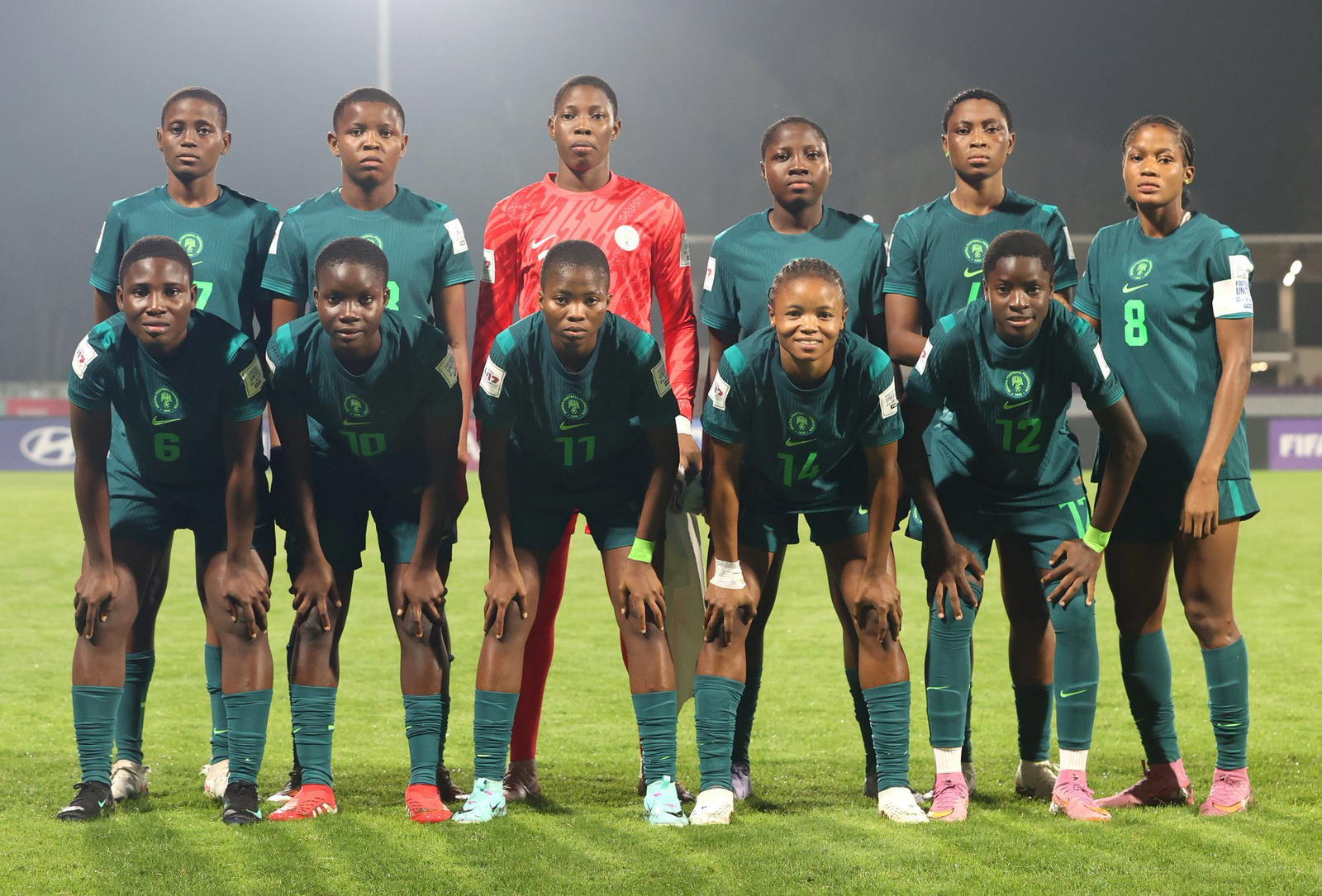 Players contest the ball during an international women’s youth football fixture.