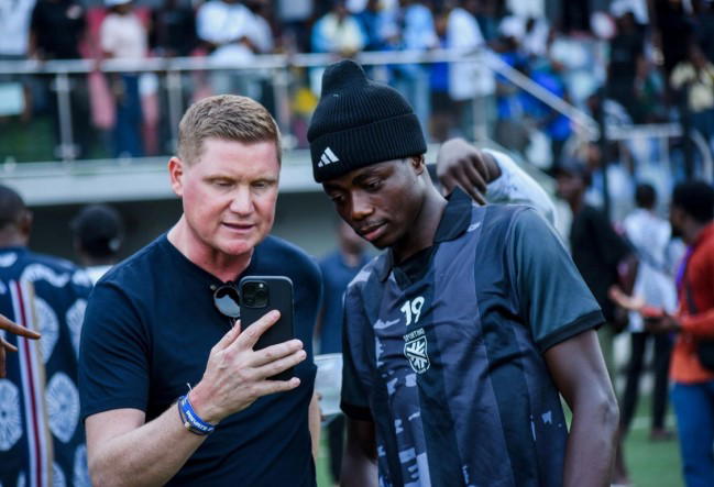 Premier League recruiter Luke Dowling with a Nigerian soccer professional at Sporting Lagos training.