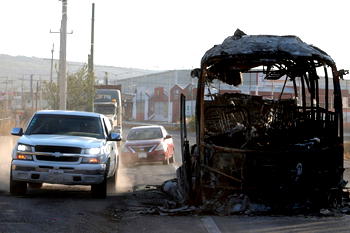Photos: Mexican president calls for calm as violence erupts after drug lord’s killing