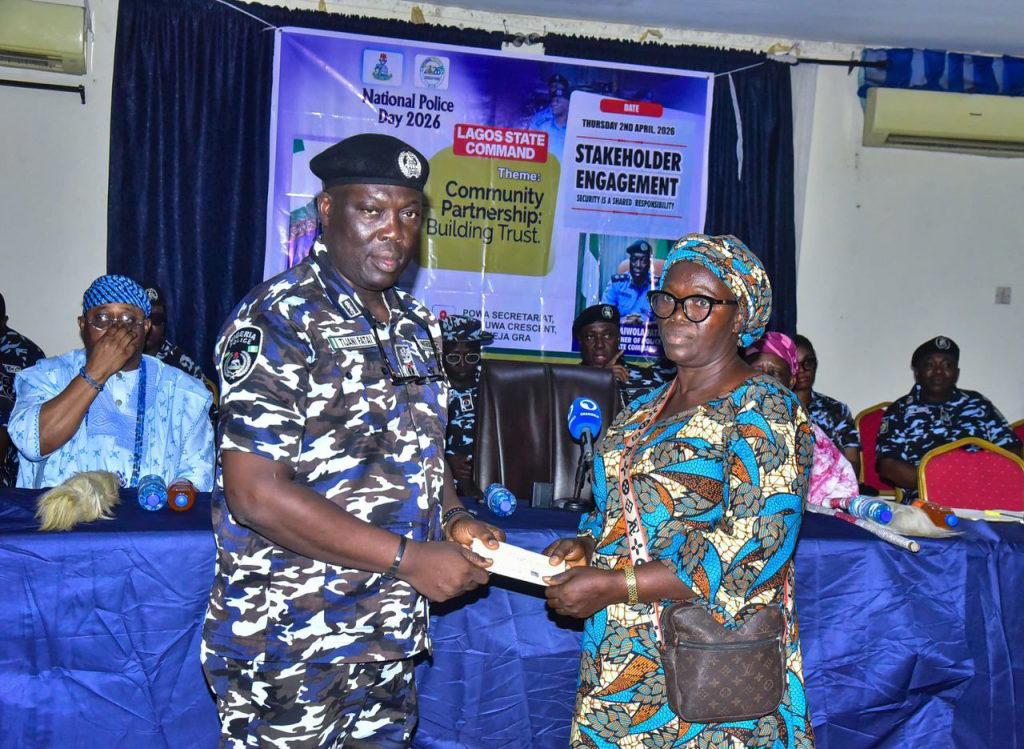 CP Fatai presenting a cheque to one of the beneficiaries.