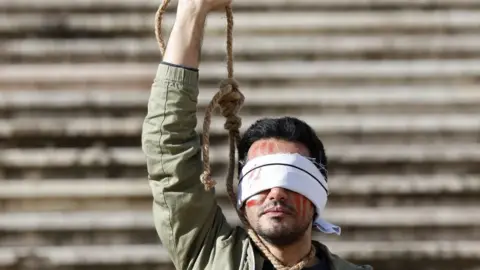 Iran announces execution of two protesters accused of setting police officers on fire