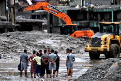 Rescuers claw through mud as Nepal, China flood missing toll nears 3,000
