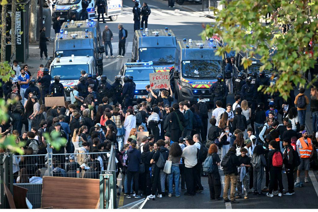 Teenager loses hand picking up grenade in France school protests